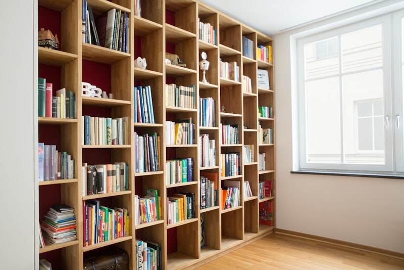 A wooden floating shelf mounted on a plain wall holding a few small objects.